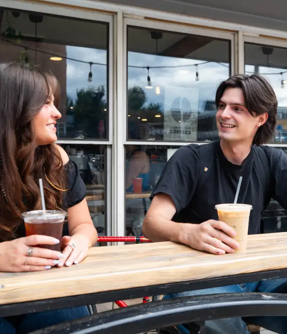 People talking with drinks in their hands